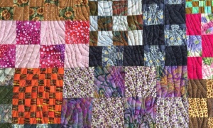Charu Patel, Kenya. 'Finishing Line' quilt (detail). As the race to find a vaccine for COVID-19 gathers momentum, I am sitting by the sideline making masks for charity. The remnants are pieced to make quilts.